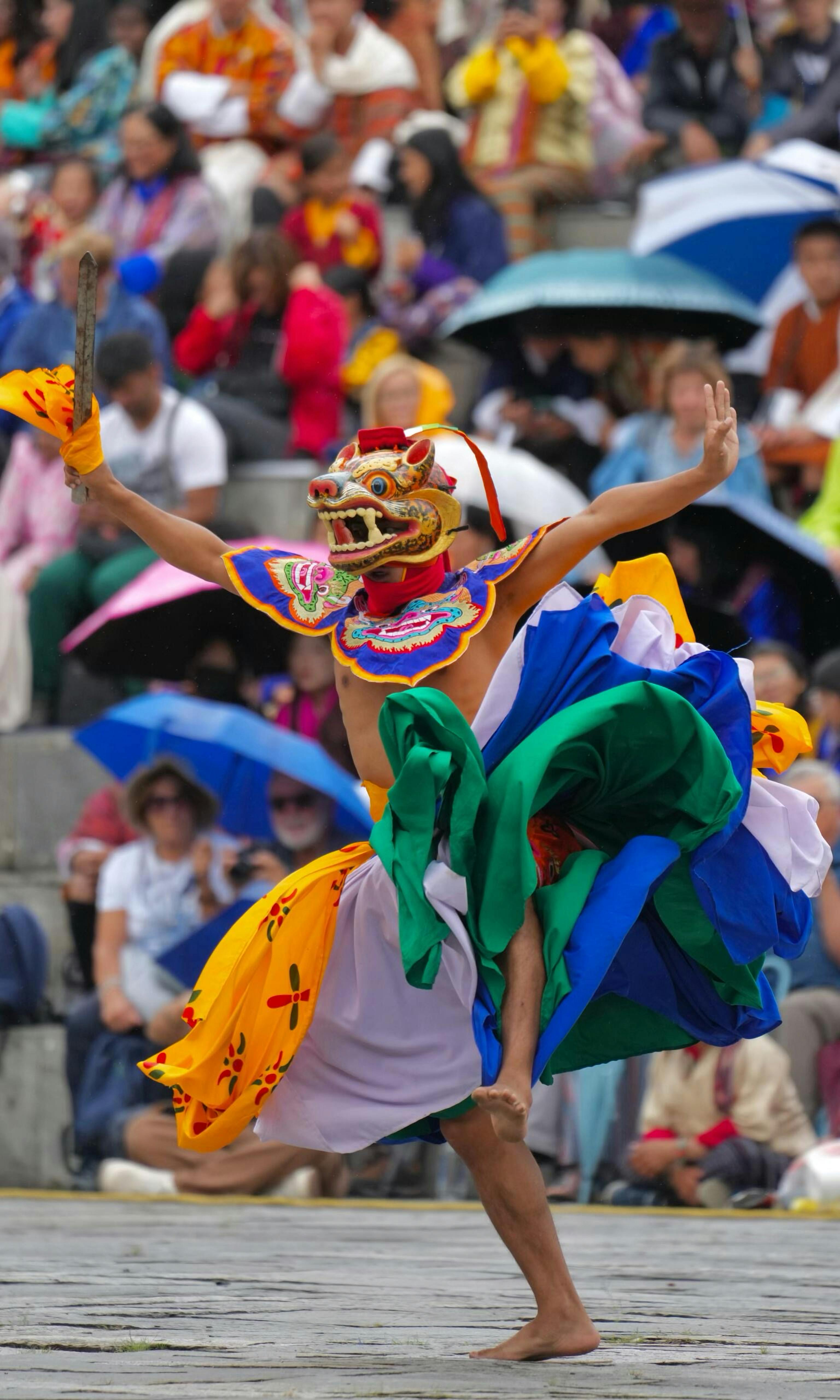 Paro Tshechu festival with traditional mask dancers in colorful costumes